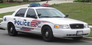 A marked Metropolitan Police Department Ford Crown Victoria Police Interceptor patrol car parked along a street.