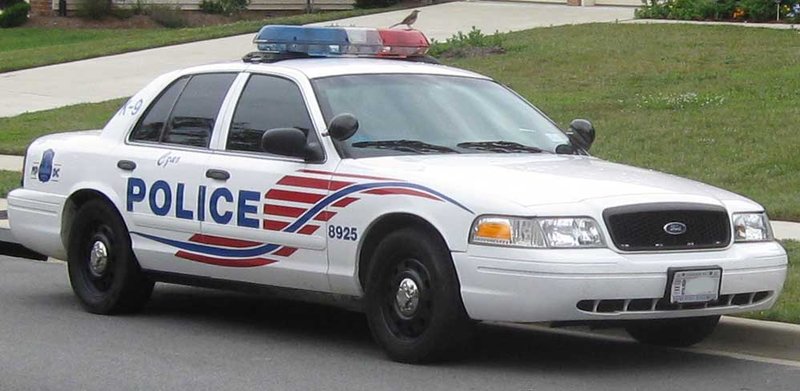 A marked Metropolitan Police Department Ford Crown Victoria Police Interceptor patrol car parked along a street.