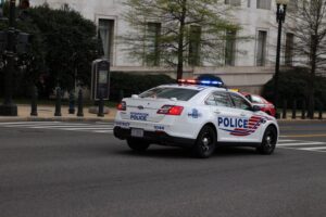 A marked Metropolitan Police Department Ford Police Interceptor patrol vehicle parked on a city street in Washington, D.C.