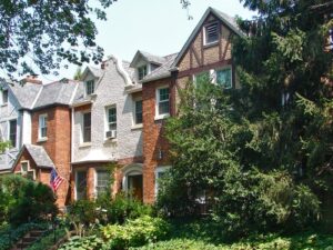 Historic residential buildings along a tree-lined street in Woodley Park in Northwest Washington, D.C.