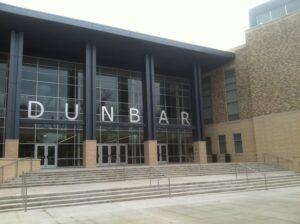The modern multi-story brick and glass facade of Dunbar High School in Washington, D.C.