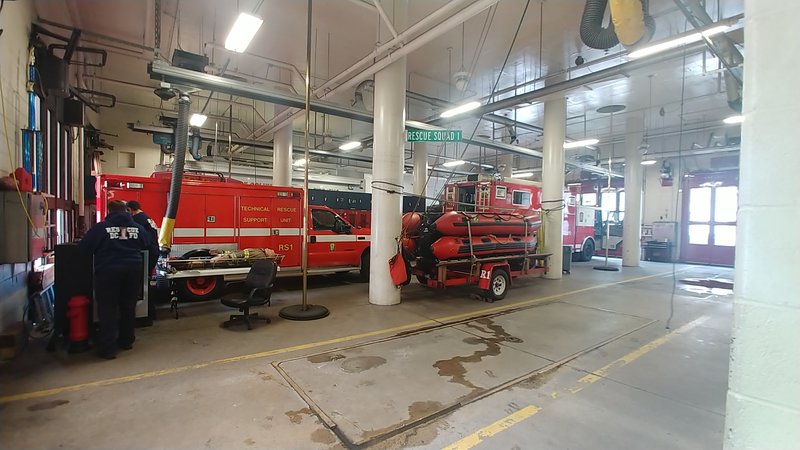 DC Fire and EMS rescue apparatus and a firefighter inside a Washington, D.C., station bay in March 2019.